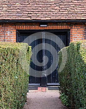 Wilbraham`s Almshouses in Hadley Green, High Barnet, North London UK. Cottages are built of red brick and have red roof tiles