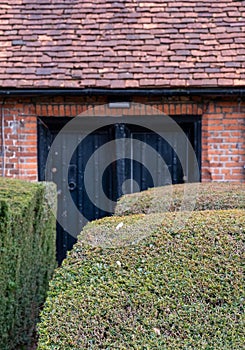 Wilbraham`s Almshouses in Hadley Green, High Barnet, North London UK. Cottages are built of red brick and have red roof tiles