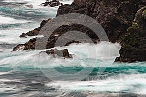 The wild Atlantic Ocean crashes against the rocks along the West