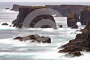 The wild Atlantic Ocean crashes against the sea stacks, rocks, and coastline