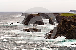 The wild Atlantic Ocean crashes against the sea stacks, rocks, and coastline