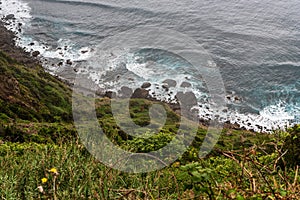 Wild Atlantic Ocean with small stone beach and waves in Madeira