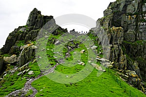 Wild Atlantic Way: Breathtaking panoramic view framed by massive rugged pinnacles above `Christ`s Valley,` on Skellig Michael.