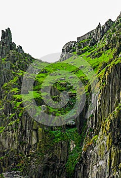 Wild Atlantic Way Ireland: Spectacular river of green spills over inhospitable craggy rock Skellig Michael Great Skellig