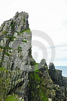 Wild Atlantic Way: Mesmerizing gigantic rocky pinnacle towers over Atlantic Ocean and `Christ`s Valley,`on Skellig Michael.