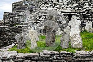 Wild Atlantic Way: Monks` remains marked by weatherworn crosses above Atlantic Ocean, Skellig Michael Monastery