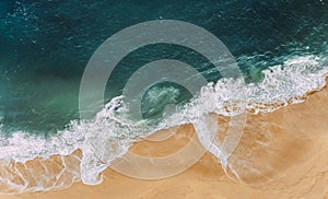 Wild beach with a beautiful clear ocean. Ocean from a bird`s eye view. Top view of the tropical beach. Paradise island.