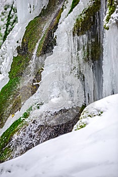 Wild beautiful waterfall in the winter, Beusnita , Romania photo