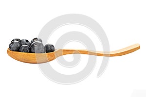 Wild blueberry in a wooden spoon isolated on a white background