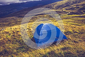 Wild camping with tent on mountain