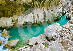 The wild canyon of Verdon Gorge with tall cliffs and a transparent green river