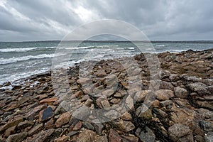 Wild coast of Normandy in winter with rocks and clouds