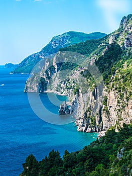 Wild coastline cliff covered with trees at Amalfi Coast, Naples, Italy