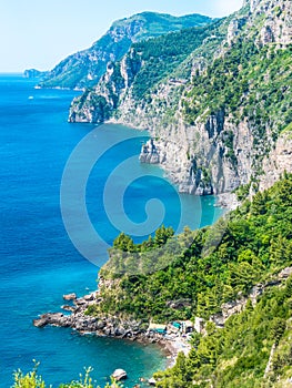 Wild coastline cliff covered with trees at Positano, Amalfi Coast, Naples, Italy