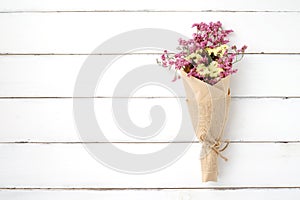 Wild flower bouquet on vintage white wood background