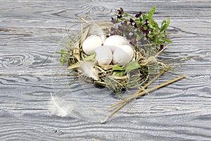 Wild flowers, church candles and nest with eggs