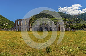 Wild flowers grow in front of the Roman ampitheater in the cathedral city of Gubbio, Italy