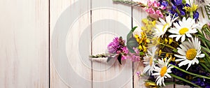 Wild flowers on old grunge wooden background chamomile lupine dandelions thyme mint bells