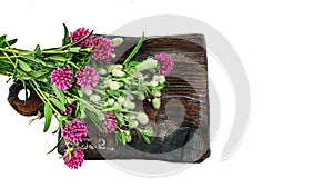 Wild flowers on an old wooden board. lovely bouquet of wild flowers on a textured board. focus on the petals of a flower