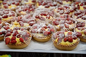 Wild fragolino strawberry and raspberry cakes in ancient city of strawberry Nemi, Castelli Romani, Italy close up