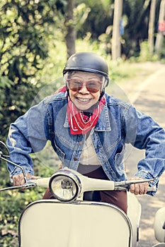 Wild and free senior woman riding vintage motorcycle