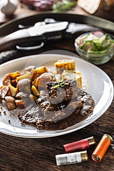 Wild game goulash stew served with roasted potatoes and seasoned with four colour pepper corn. Whole food is surrounded by hunting