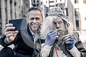 Wild grey-haired dirty man being focused on money in his hands