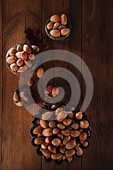 Wild haselnut in iron bowls on wooden table