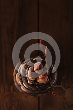 Wild hazelnut in iron bowls stacked on wooden table