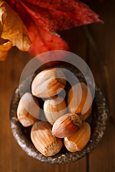 Wild hazelnut in iron bowls on wooden table