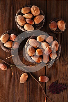 Wild hazelnut in iron bowls on wooden table