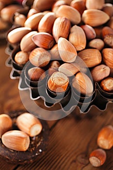 Wild hazelnut in iron bowls on wooden table