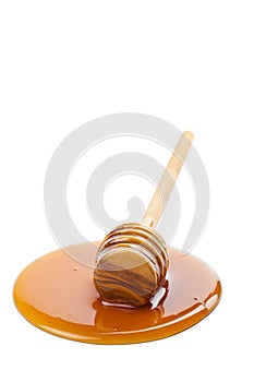 Wild honey and wooden dipper isolated