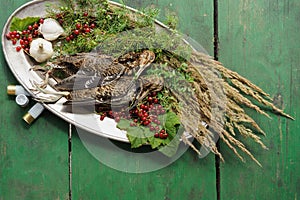 Wild hunting fowls in cooking. Two snipe or woodcock lie on metal dish. Wildfowl hunting.