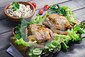 Wild and long grain white rice in a wooden bowl, two baked chick