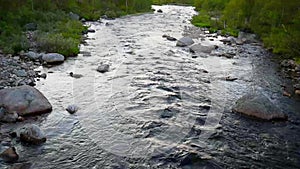 Wild mountain river flowing through stones