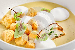 Wild mushroom cream soup with cheese profiteroles