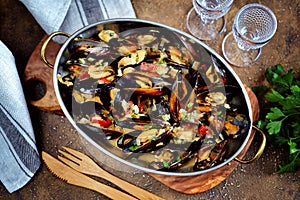 Wild mussels in shells with tomatoes, onions, bacon, garlic and parsley in white wine.