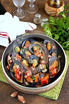 Wild mussels in shells with tomatoes, onions, bacon, garlic and parsley in white wine.