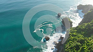 Wild nature with cliff, rocks and ocean in Bali. Aerial view