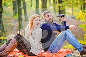 Wild outdoor. couple in love relax in autumn forest with tea or coffee. camping and hiking. surprised girl drink mulled