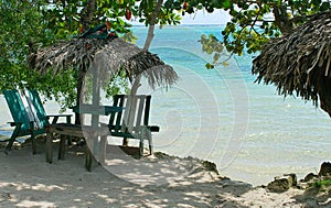 Wild public beach with green chairs