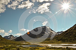 Wild river in the Jotunheimen National Park in Norway with mountain Styggehoe - way to the Spiterstulen settlement