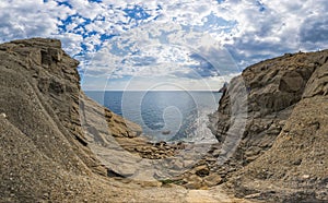 Wild rock beach with natural rock formation. The concept of an active and healthy life in harmony with nature