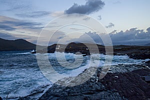 Wild and rugged landscape around Valentia Island's lighthouse in County Kerry, Ireland, during dusk.