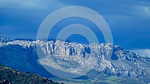 Wild rugged mountain landscape against blue cloudless sky