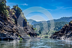 Wild and scenic Rogue River in Southern Oregon with a distant rafter floating. photo