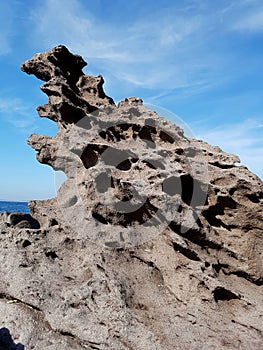 Wild sea rock view against blue sky. Portoscuso, Sardinia Italy