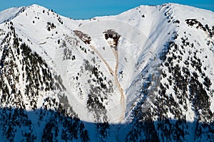 Wild snowy slope with slab avalanche occurred. photo