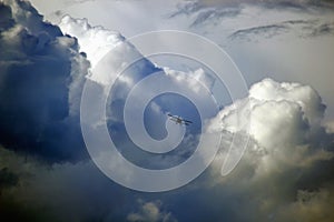 Wild stormy clouds on the sky with airplane